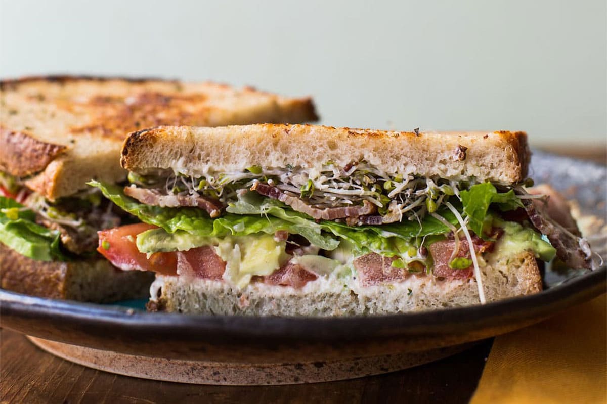 California-style BLT sandwich on plate.