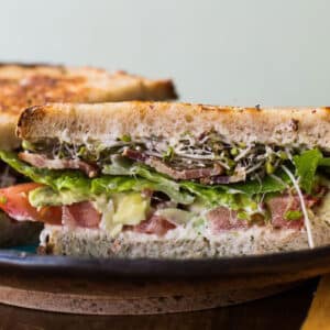 California-style BLT sandwich on plate.