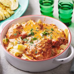 Chicken Paprikash in a handled bowl.
