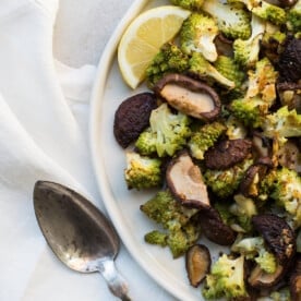 Roasted Broccoflower and Shiitake Mushrooms with Rosemary and Garlic on white plate.