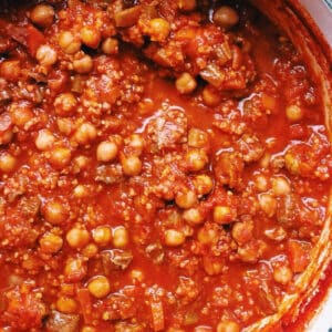 Lamb Chorba in Dutch oven on wood table.