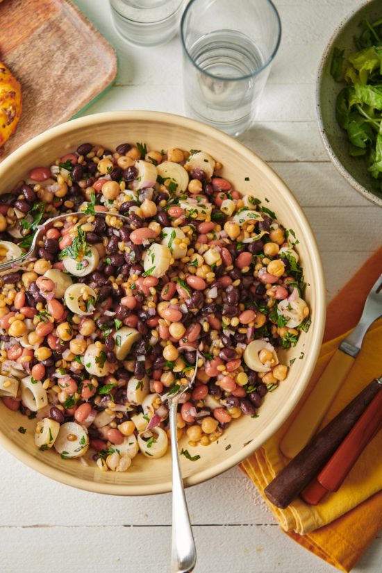 Two spoons in a bowl of Modern Three Bean Salad.