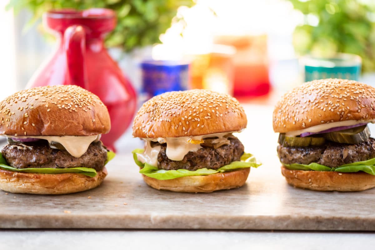 Line of three Asian beef mushroom burgers.