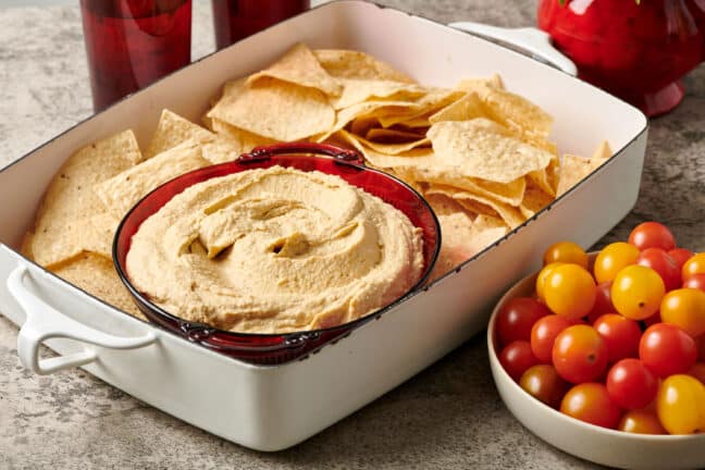 Pan of chips with a bowl of hummus.
