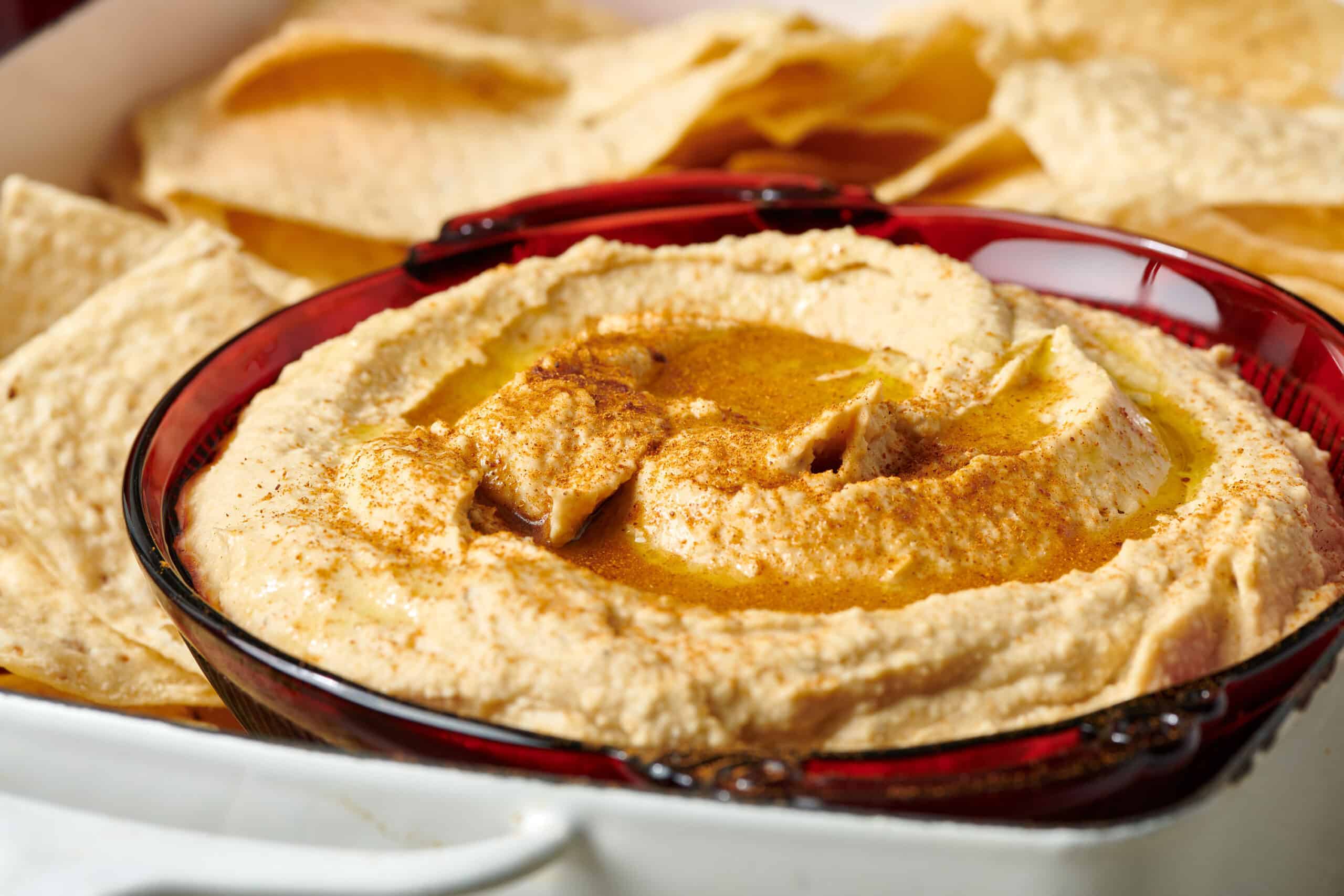 Bowl of Hummus topped with olive oil and spices.