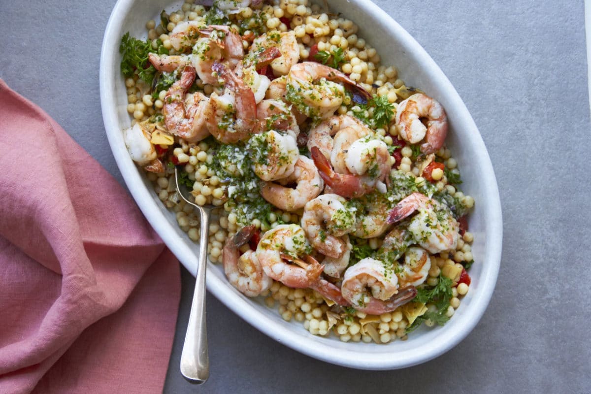 Couscous Salad with Shrimp, Roasted Tomatoes and Pesto Dressing in a serving bowl