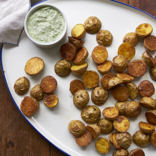 Roasted Potatoes with Arugula-Basil Dipping Sauce on white plate.