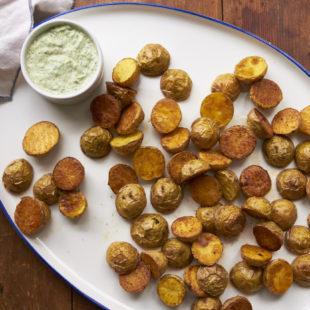 Roasted Potatoes with Arugula-Basil Dipping Sauce on a serving platter.