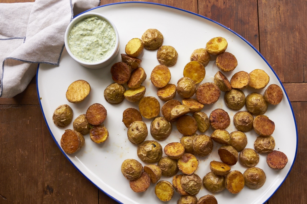 Roasted Potatoes with Arugula-Basil Dipping Sauce on a serving platter.