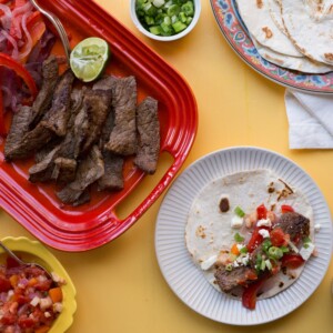 Steak Fajita on a plate surrounded by fajita ingredients.