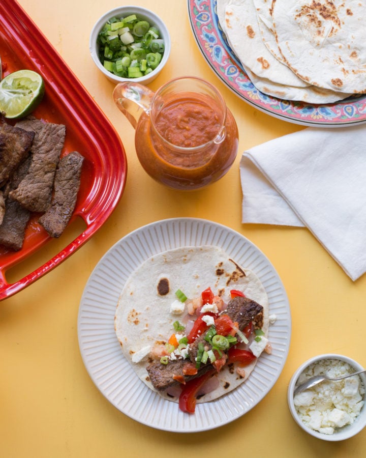 Table set with Steak Fajita filling and toppings.