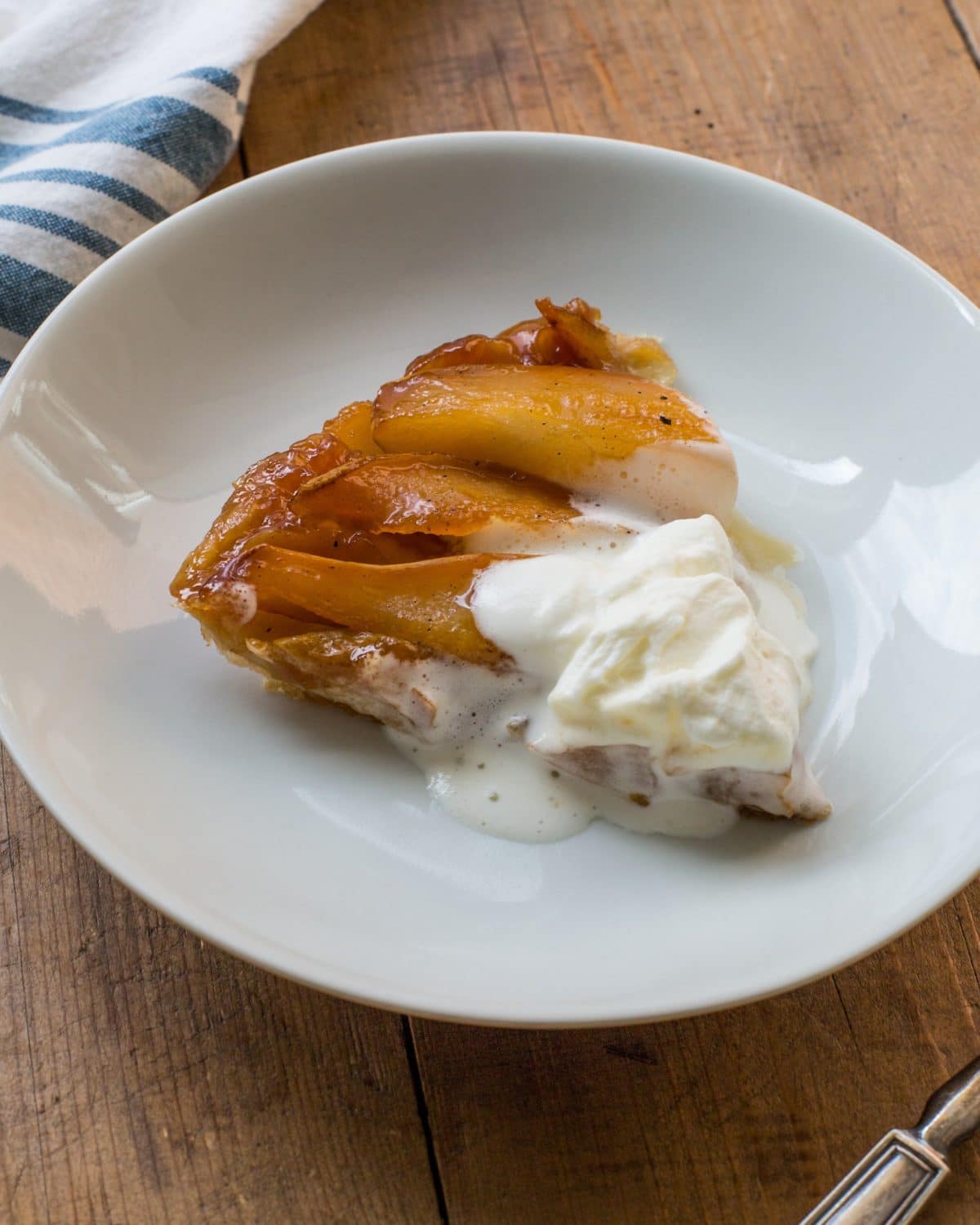 Slice of Pear Tart Tatin on a plate.