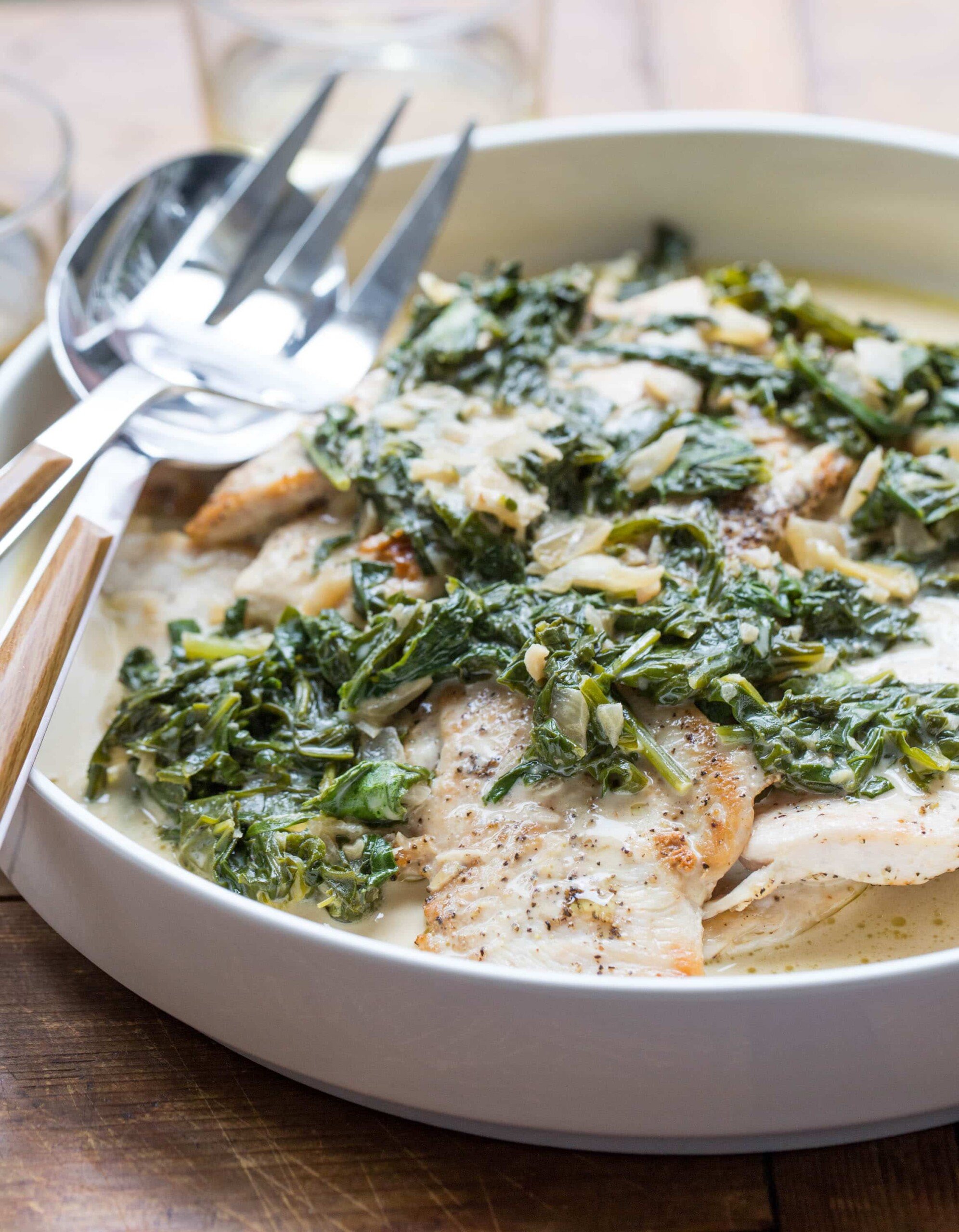 Serving ware in a dish of Chicken with Arugula and Mustard Pan Sauce.