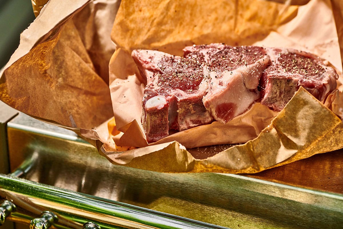 Seasoned Lamb Chops on brown paper.