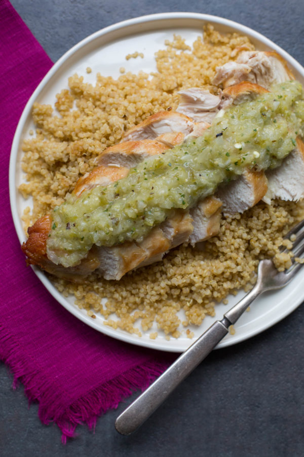 Plate of Pan-Seared Chicken Breasts with Roasted Tomatillo Salsa over couscous.