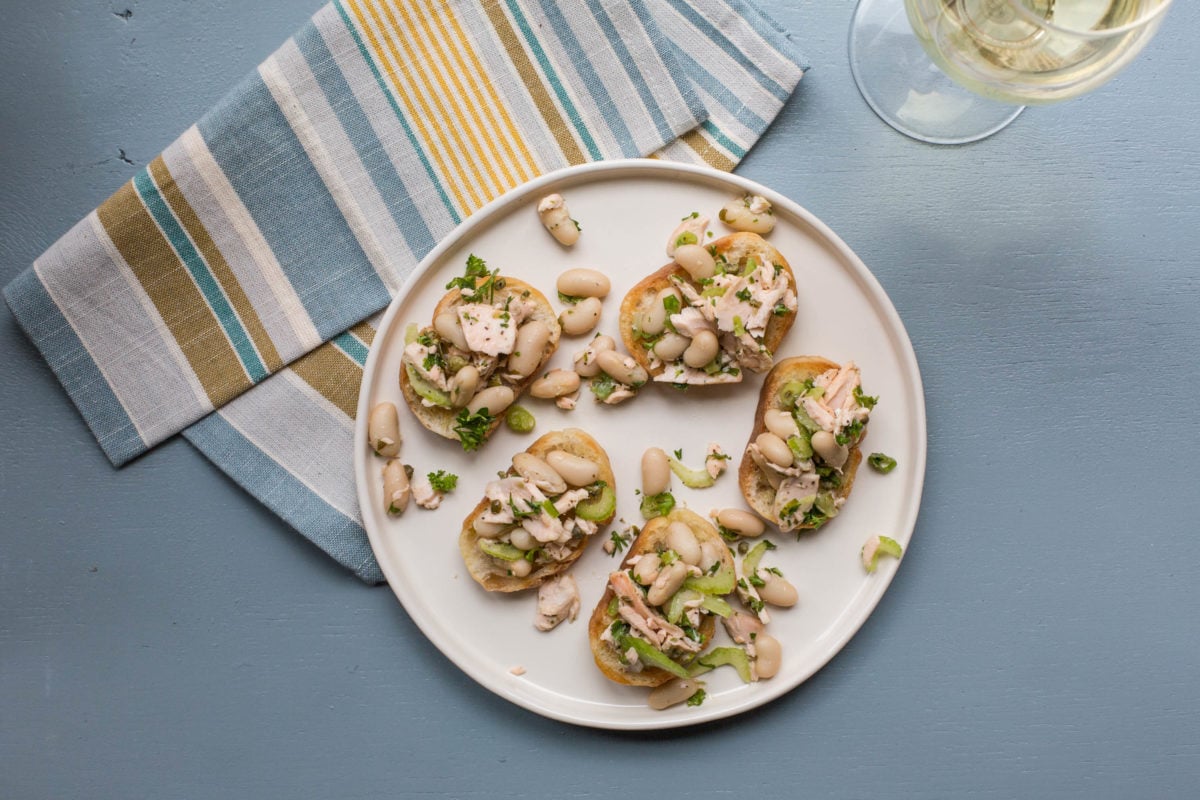 Salmon and White Bean Bruschetta on a white plate.