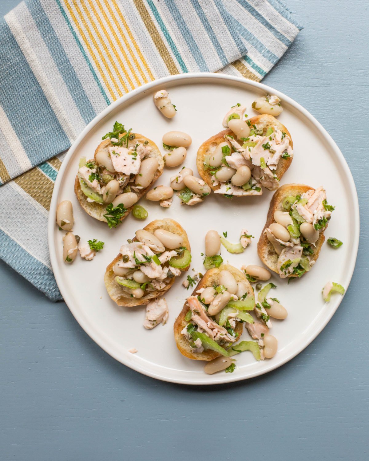 White plate of Salmon and White Bean Bruschetta.