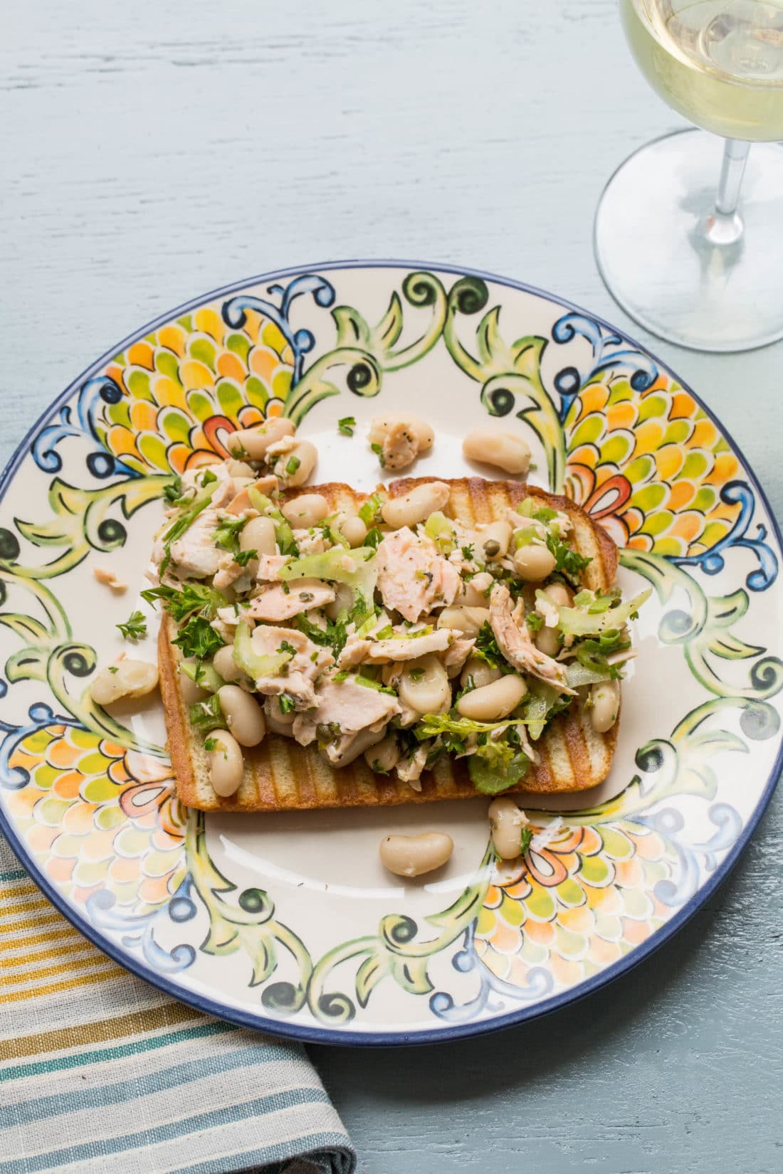 Colorful plate with a Salmon and White Bean Bruschetta.