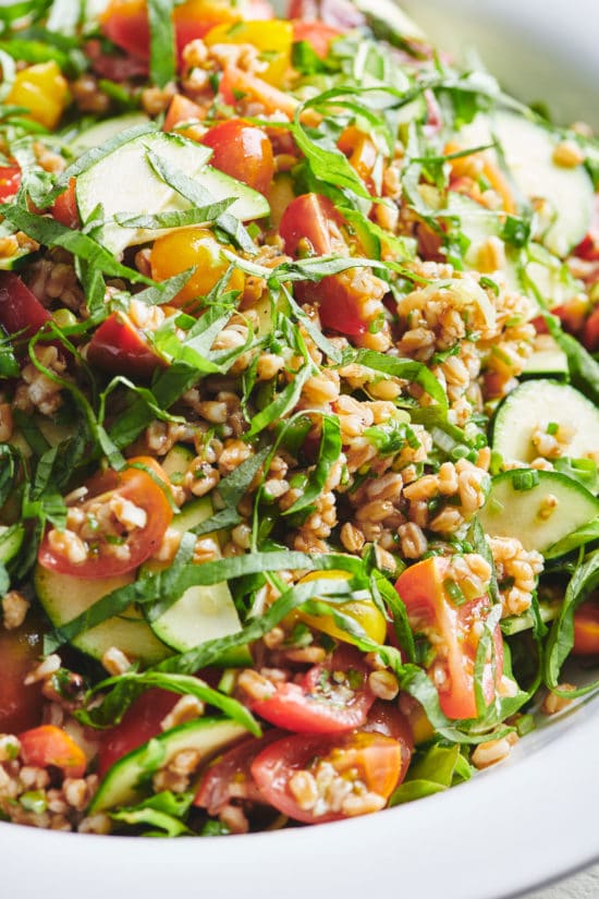 Summer Whole Grain and Vegetable Salad piled with farro, squash, and tomatoes.