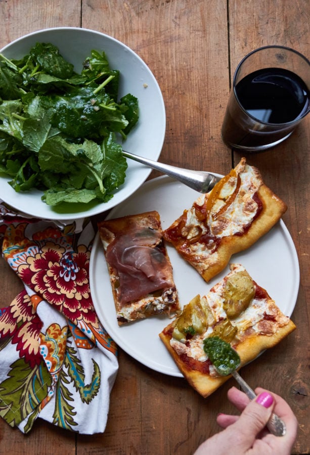 Three slices of Pizza Quattro Stagioni on a plate.