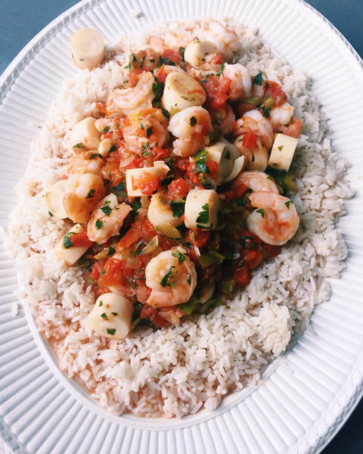 Casserole of shrimp and hearts of palm on a bed of rice.