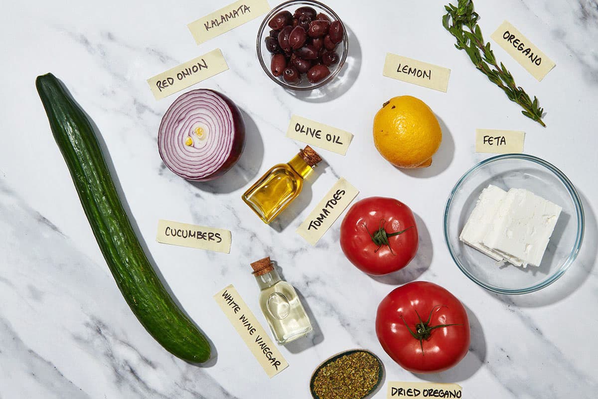 Fresh tomatoes, cucumber, feta cheese, and other ingredients for a Greek salad.