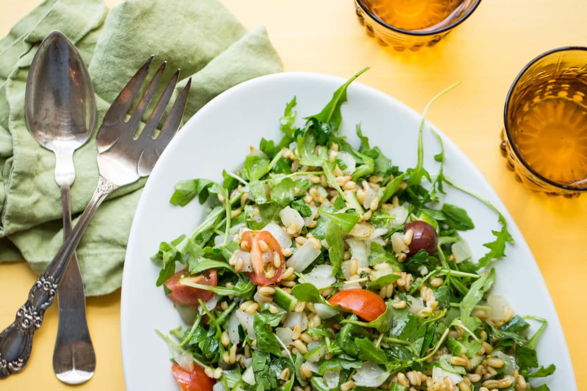 Kamut Tabbouleh Salad piled high on a white dish.