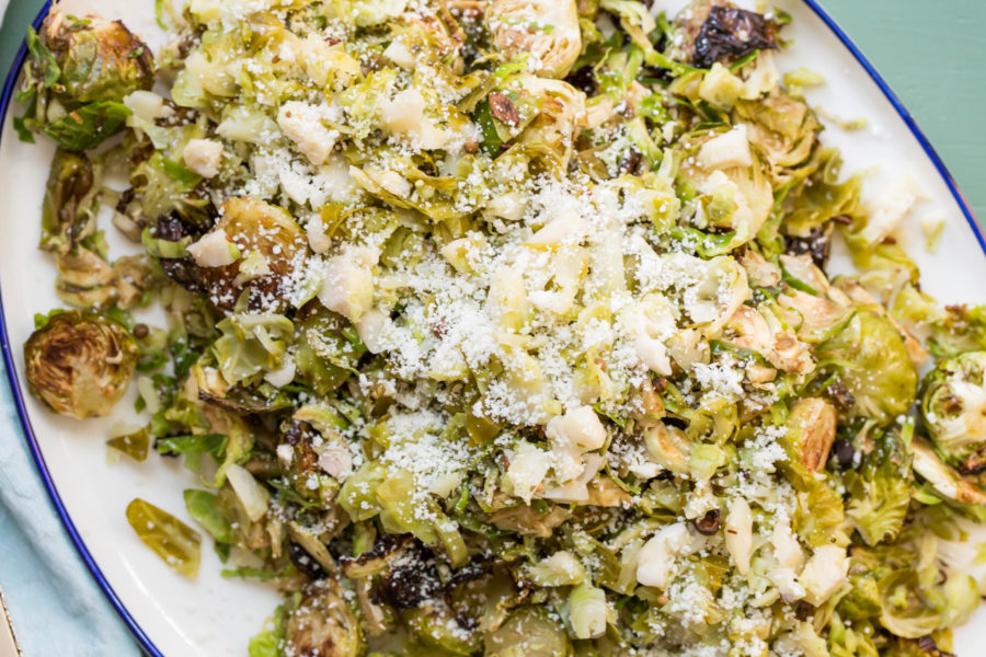 Brussels Sprouts Three Ways topped with grated cheese.