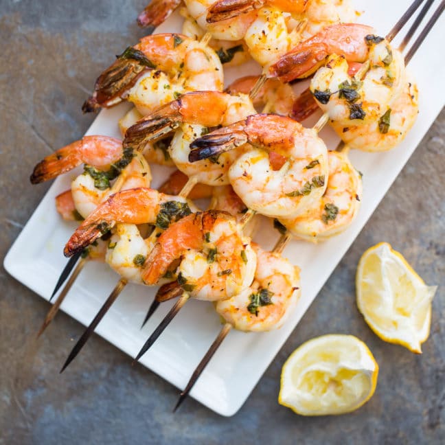 Citrus Basil Shrimp Kebabs piled on a plate.