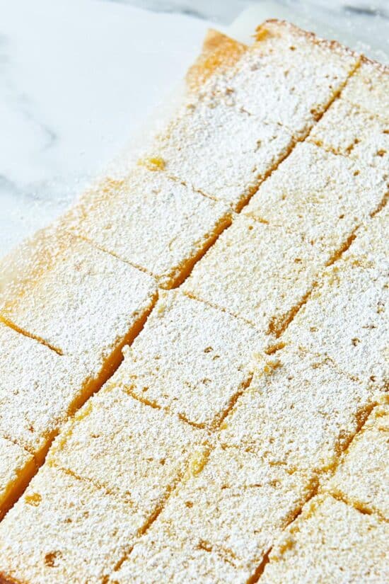 Sliced Lemon Squares on parchment paper.