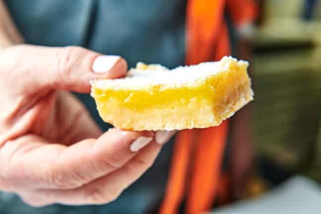 Woman holding a Lemon Square.