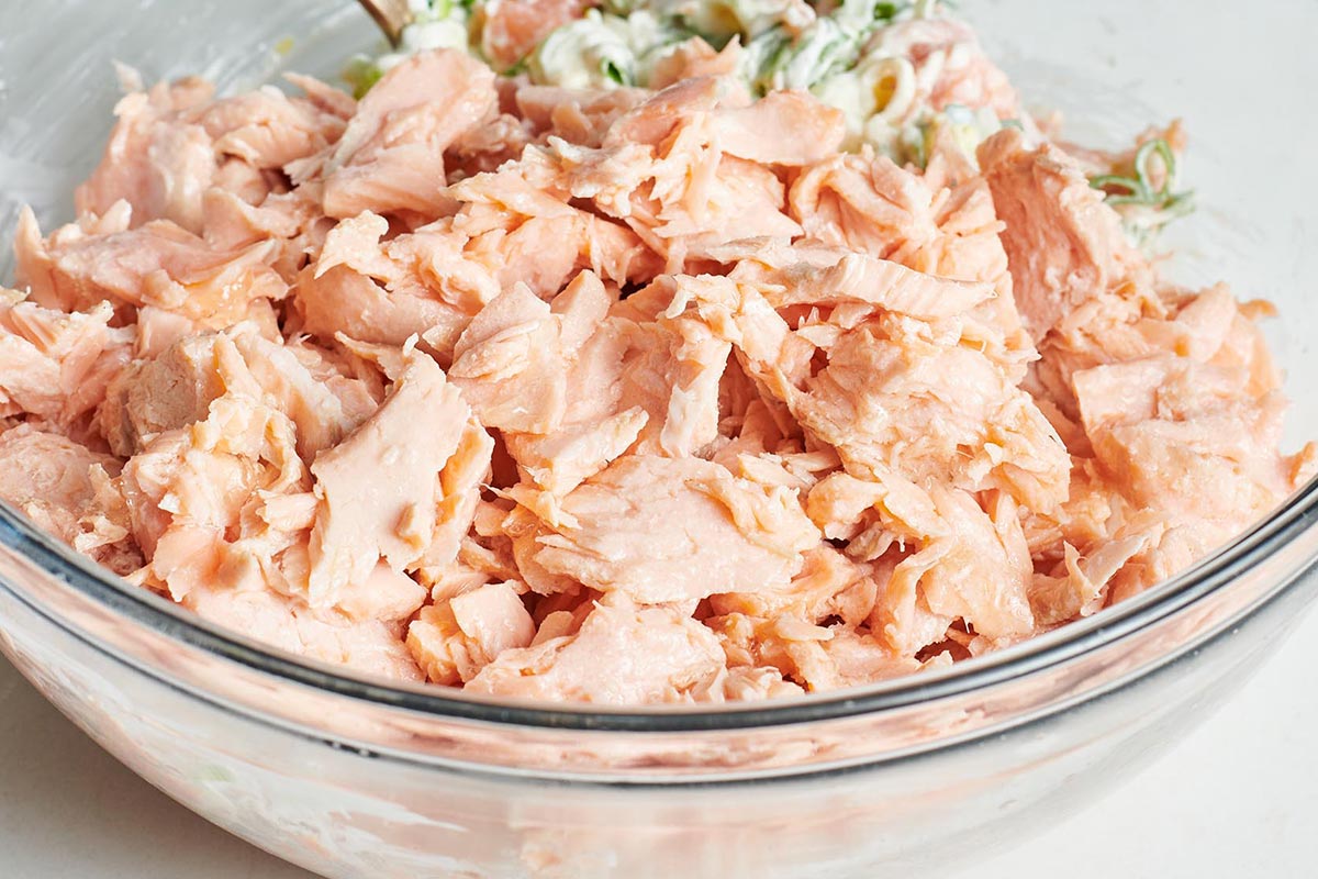 Flaked salmon in glass bowl.
