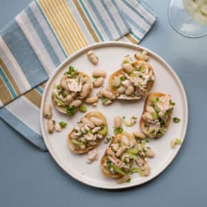 White plate of Salmon and White Bean Bruschetta.