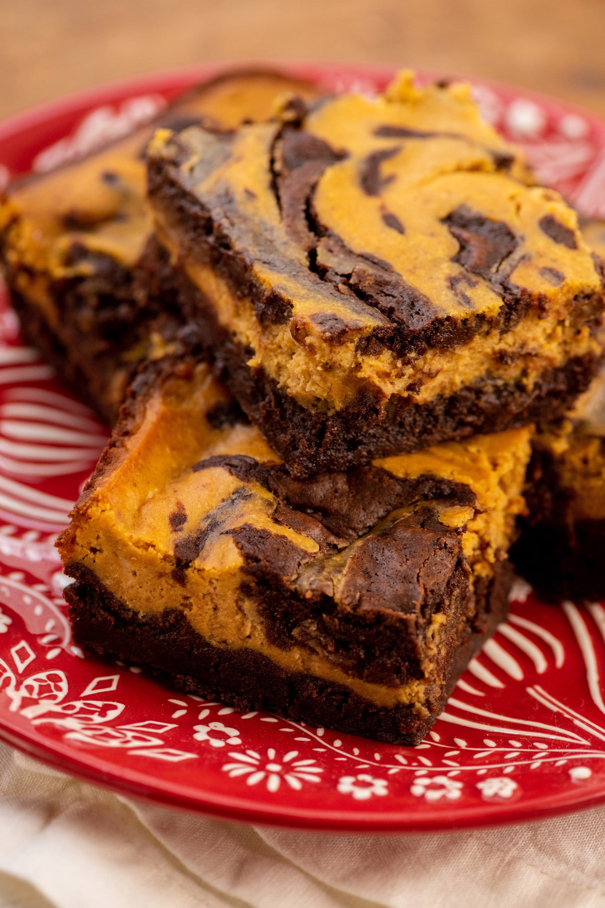 Pumpkin Cream Cheese Brownies on a red plate.