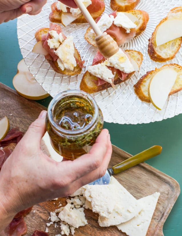 Thyme-infused honey drizzling over Prosciutto, Asian Pear and Blue Cheese Crostini.