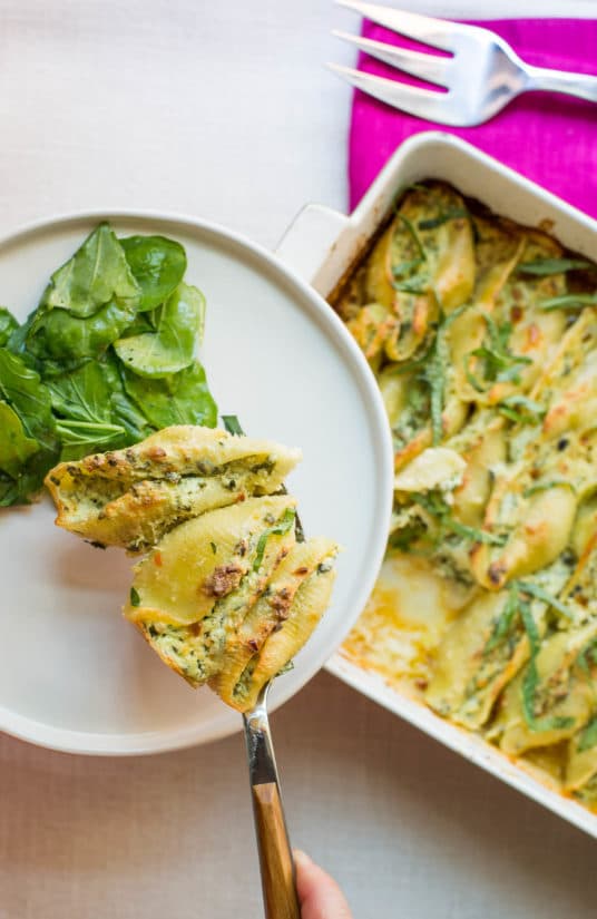 Spinach and Cheese Stuffed Shells on a plate with salad.