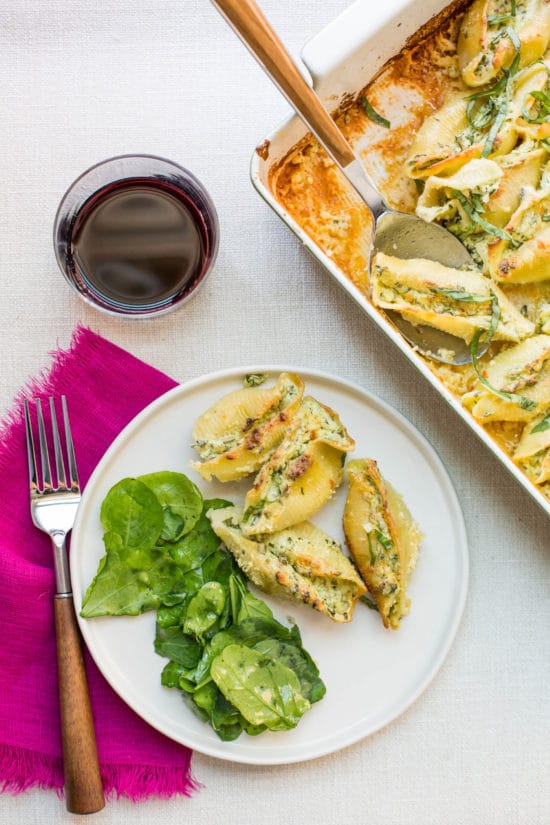 Spinach and Cheese Stuffed Shells on a plate with salad.