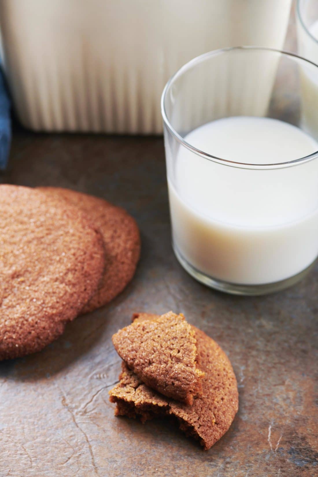 Molasses Cookies next to a cup of milk.
