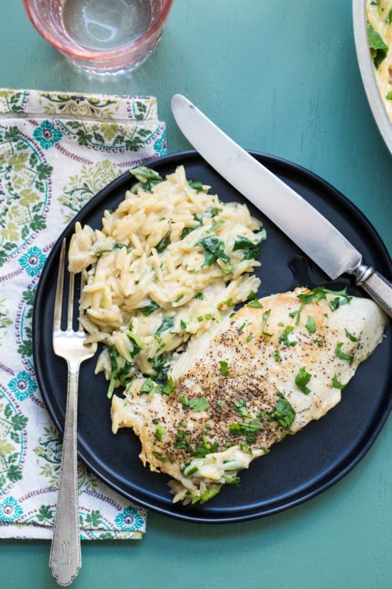 Cheesy Chicken and Orzo on a black plate.