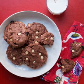 Big Chewy Brownie Cookies with Dried Cherries and White Chocolate Chips on a white plate.