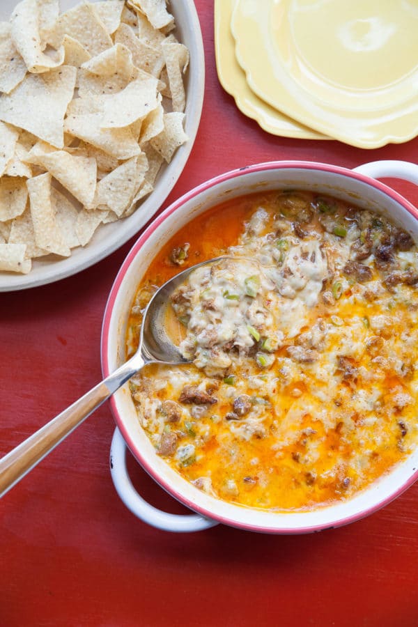 Spoon in a bowl of Queso Fundido with Chorizo.