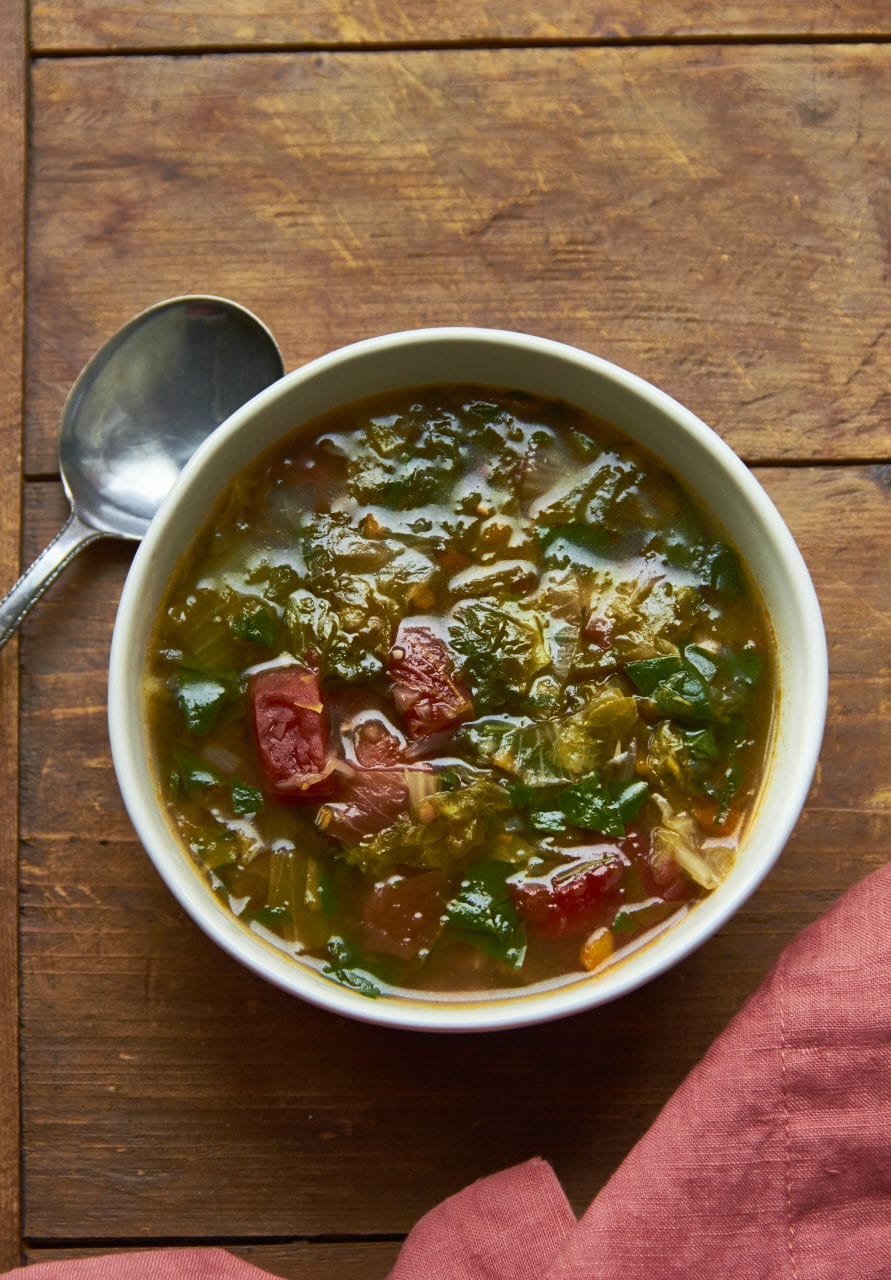 Escarole and Spinach Soup in a white bowl.