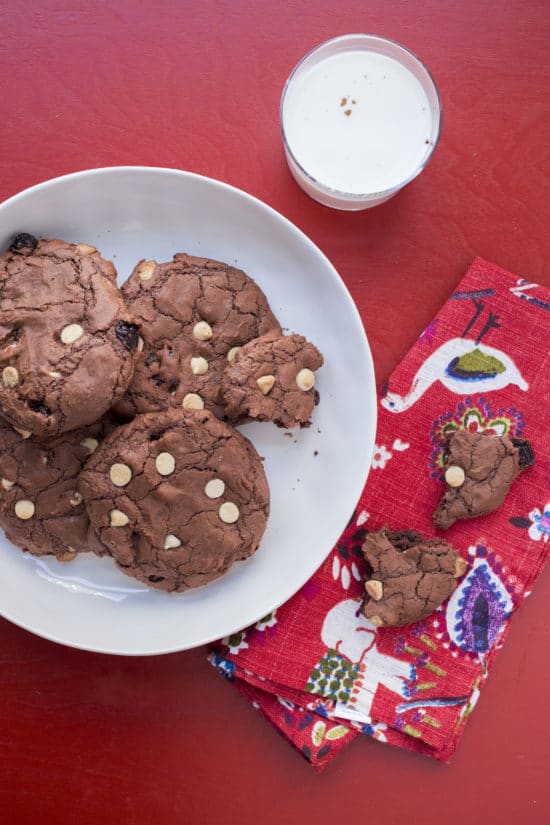 Big Chewy Brownie Cookies with Dried Cherries and White Chocolate Chips on and off a plate.