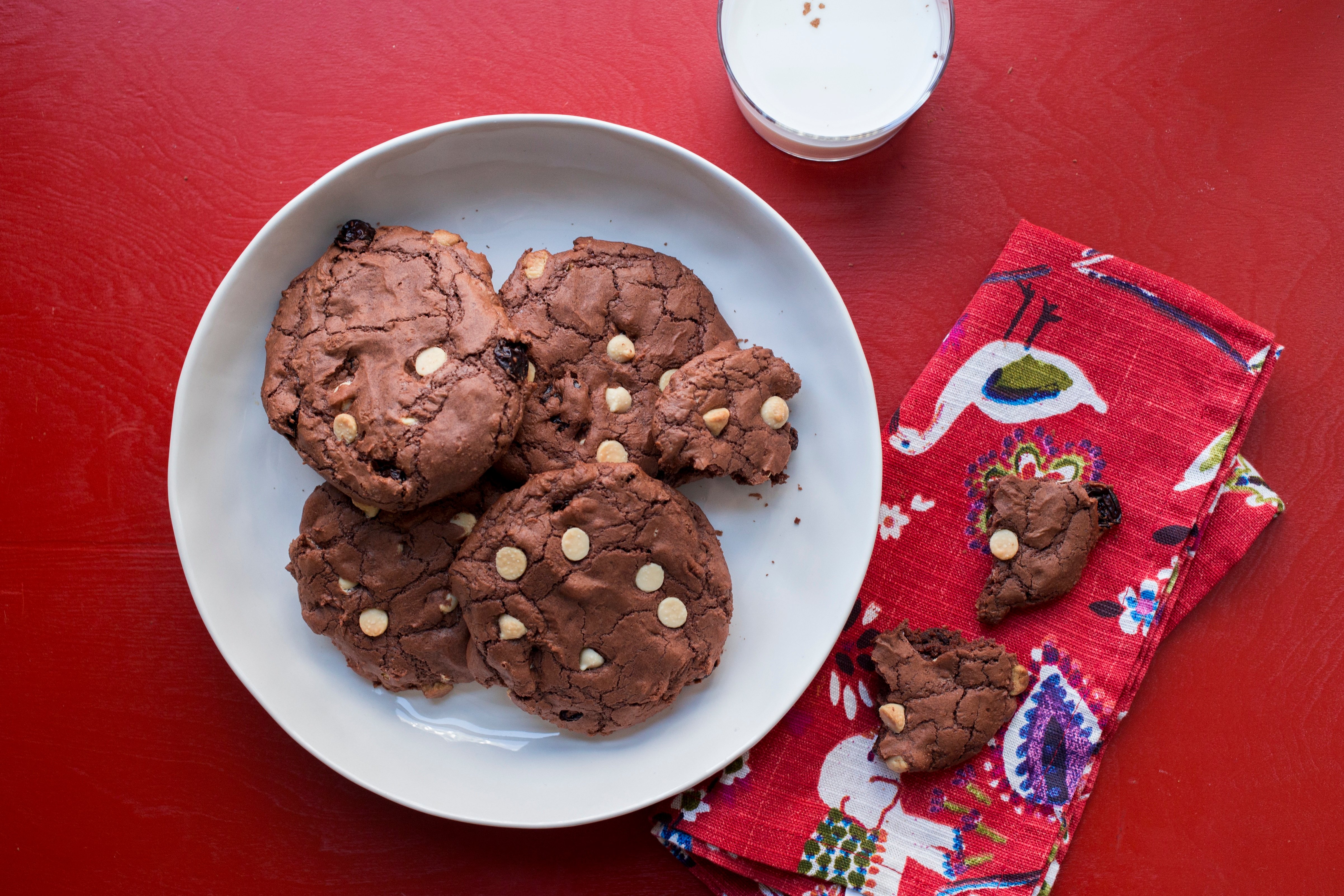 Big Chewy Brownie Cookies with Dried Cherries and White Chocolate Chips on a white plate.