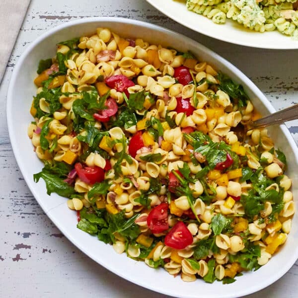 White, oblong bowl of Mayo-Free Vegan Pasta Salad.