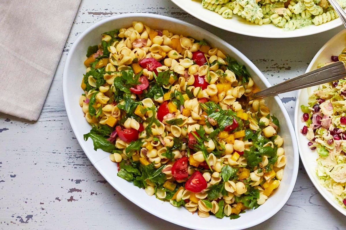 White, oblong bowl of Mayo-Free Vegan Pasta Salad.