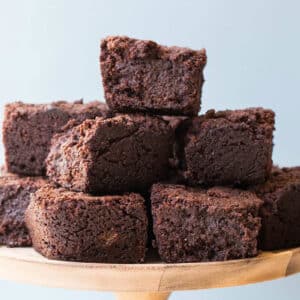 Stack of hot chocolate brownies on wood platter.