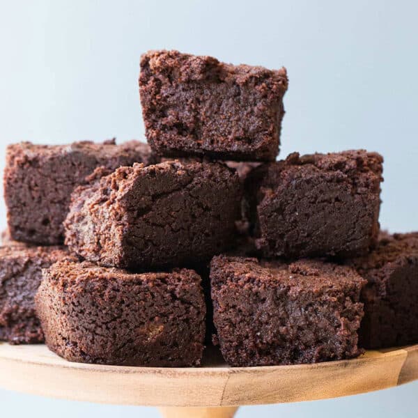 Stack of hot chocolate brownies on wood platter.