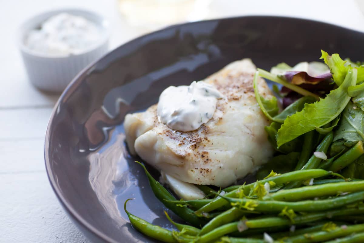 Cod topped with a Simple Fresh Herb Sauce.