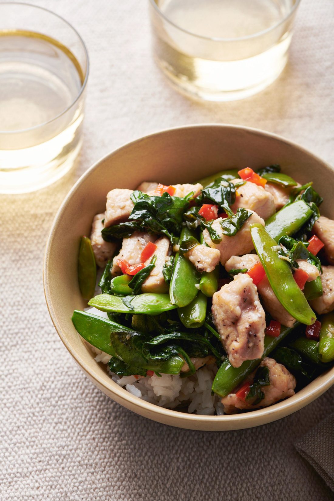 Bowl of Chicken and Spinach Stir-Fry with Ginger and Oyster Sauce.